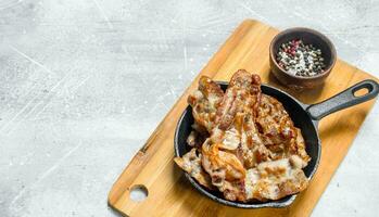 Fried bacon with spices. photo