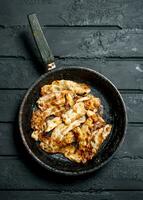 Fried bacon in a frying pan. photo