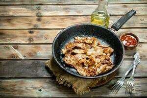 Fried bacon with tomato sauce. photo