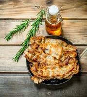 Fried bacon with olive oil and rosemary. photo