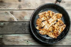 Fried bacon in a pan. photo