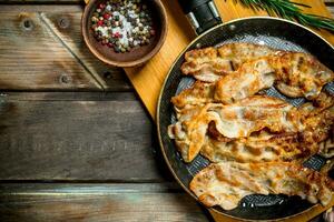 Fried bacon with garlic and spices. photo