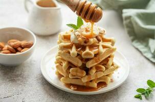 Belgian waffles with fruit, bananas and honey. Homemade baking. photo