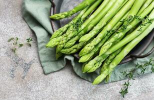 Fresh green asparagus on  concrete background. photo