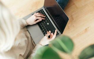 Young woman holding credit card and using laptop computer. photo