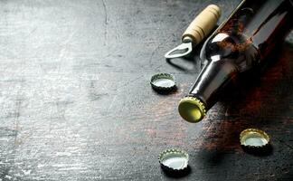 Glass beer bottle and opener. photo