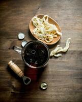 Beer in a mug and squid rings in a bowl. photo