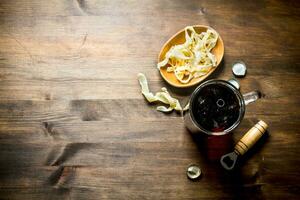 Beer in a mug and squid rings in a bowl. photo