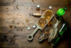 Glasses of beer on a stand and dried fish. photo