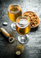 Beer in glasses and crumbs on a plate. photo