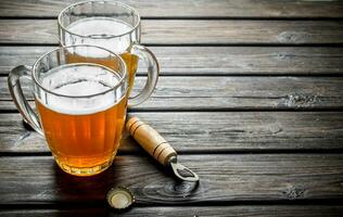 Beer mugs and opener. photo