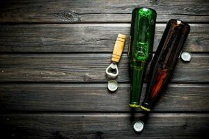 Beer in glass bottles and opener. photo