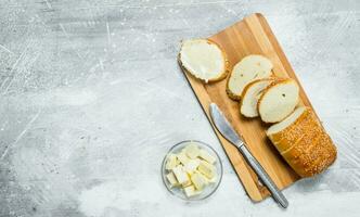 Breakfast. Fresh bread and butter on a wooden Board. photo