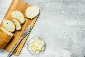 Breakfast. Fresh bread and butter on a wooden Board. photo