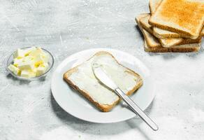 Breakfast. Toasted bread and butter. photo