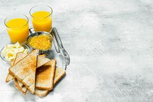 Toasted bread with butter and orange jam. photo