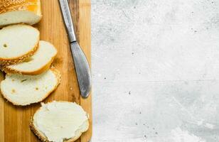 Breakfast. Fresh bread and butter on a wooden Board. photo