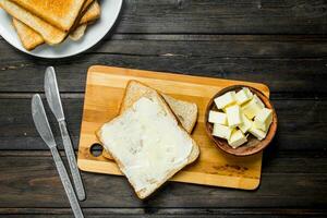 Toasted bread and butter on the Board. photo