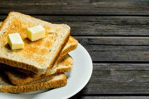 Breakfast. Toasted bread and butter on a plate. photo