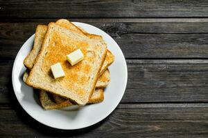 Breakfast. Toasted bread and butter on a plate. photo