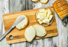 Fresh bread and butter on the Board . photo