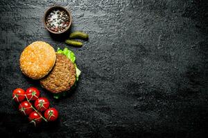 Burger with tomatoes,cucumbers and spices. photo
