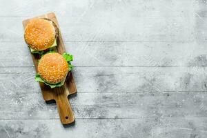 Burgers on a wooden stand. photo