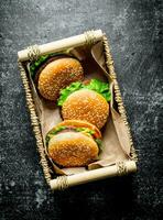 Burgers with beef and vegetables in the basket. photo