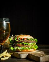 Burger with beer in a glass and fries. photo