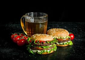 Burgers with beer and tomatoes. photo