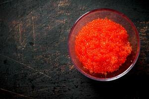 Red caviar in a glass bowl. photo