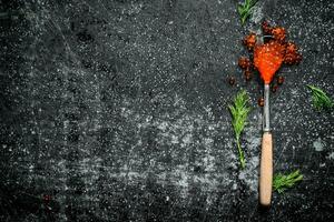 Red caviar in a spoon with dill. photo