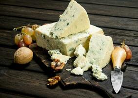 Blue cheese with walnuts and grapes. photo