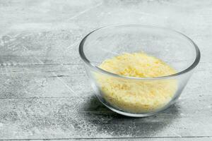 Grated cheese in a glass bowl. photo