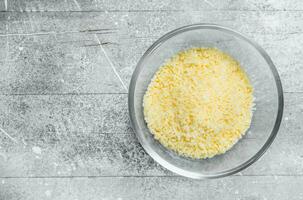 Grated cheese in a glass bowl. photo