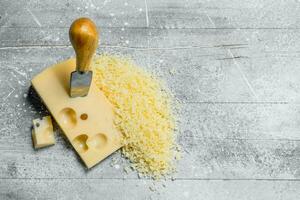 Grated cheese with knife. photo