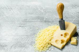 Grated cheese with knife. photo