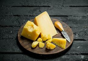 Parmesan cheese on a wooden Board. photo