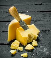 Parmesan cheese with knife. photo