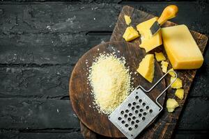 Grated Parmesan cheese on a wooden Board. photo