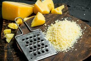 Grated Parmesan cheese on a wooden Board. photo