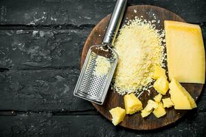 Grated Parmesan cheese on a wooden Board. photo