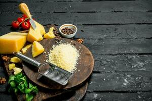 Grated Parmesan cheese with pine nuts, tomatoes and herbs. photo