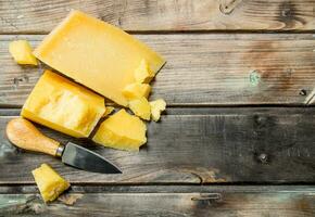 Parmesan cheese with knife. photo