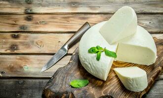 Soft cheese with mint leaves. photo