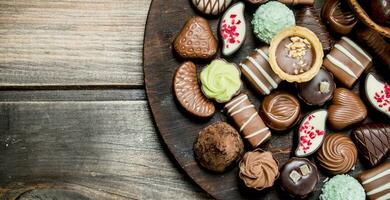 Chocolate sweets on a wooden Board. photo