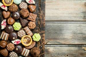 Chocolate sweets on a wooden Board. photo