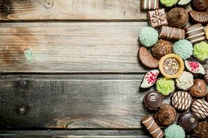 Chocolate sweets with nuts and various fillings. photo