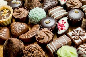 Chocolate candies with nuts and various fillings. photo