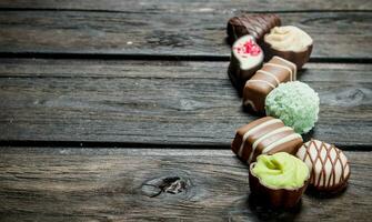 Chocolate sweets with nuts and various fillings. photo